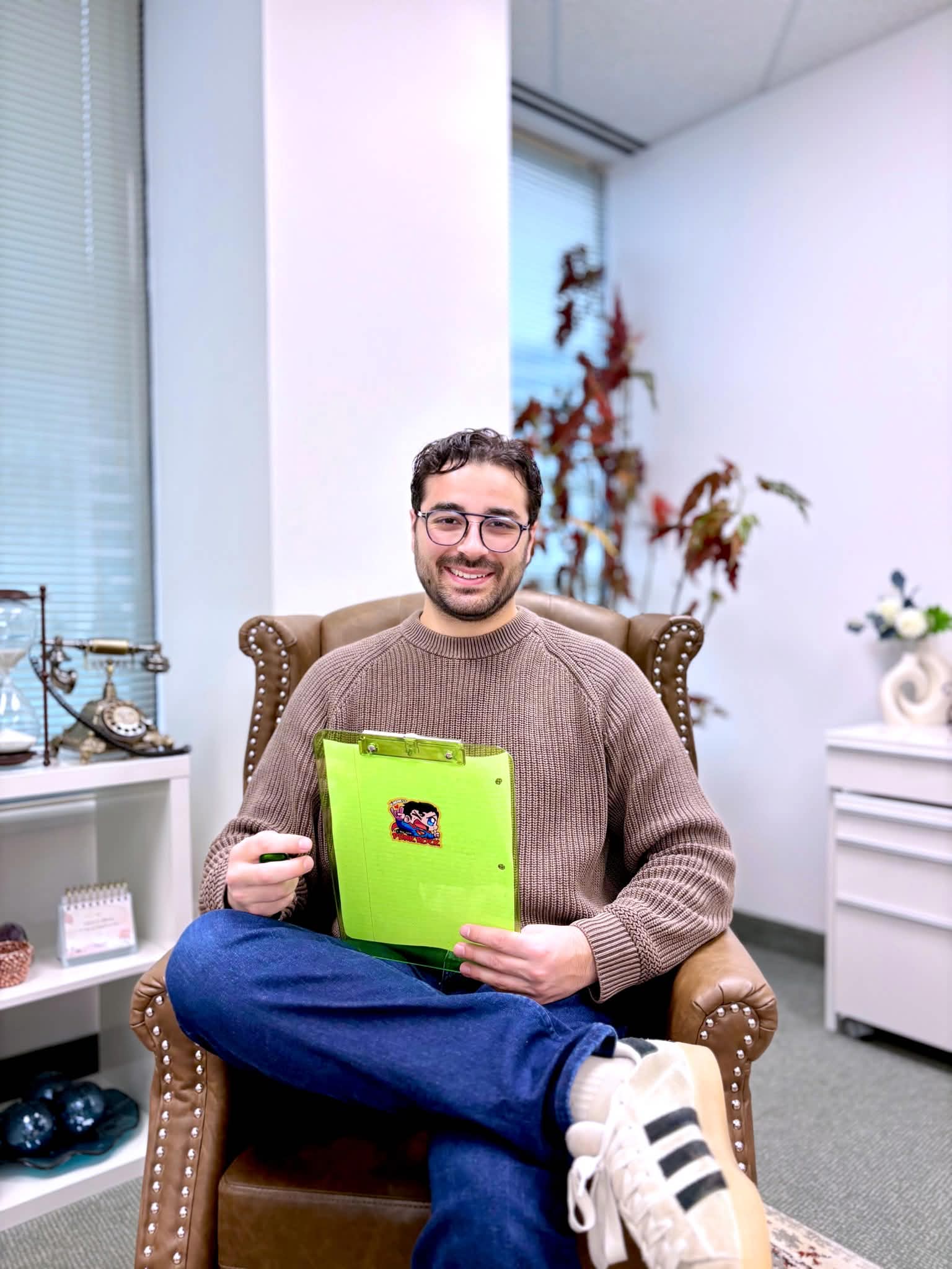 Filippo Folino smiling in a leather armchair in his Concord office
